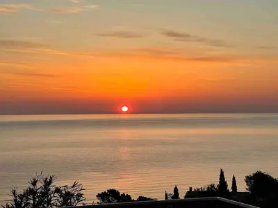 a sunset over the water with the sun in the sky at Villa with pool, sea view, Ste Lucie de Porto-Vecchio in Conca