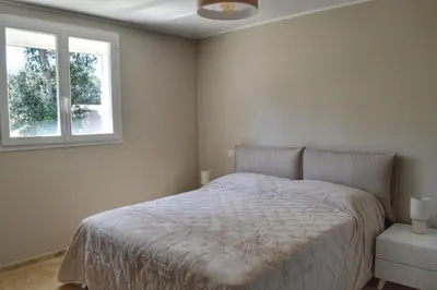 a bedroom with a bed and a window at Villa Serena - 10mn de la plage in Bonifacio