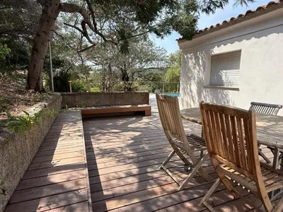 a patio with two chairs and a table and a bench at Villa Solanella in Coti-Chiavari