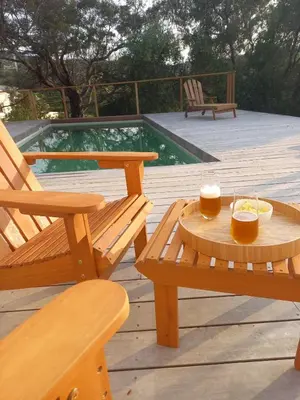 a deck with two benches and a table with drinks on it at Villa Solanella in Coti-Chiavari