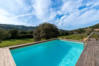 a swimming pool with a view of a mountain at A Casetta Rossa Bergerie a 15 min du centre ville d Ajaccio et 15 min des plages de Porticcio in Ocana
