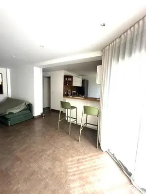 a living room with two chairs and a kitchen at Pietrosella Canelli Sea View in Pietrosella