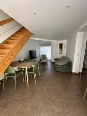 a living room with a table and chairs and a bed at Pietrosella Canelli Sea View in Pietrosella