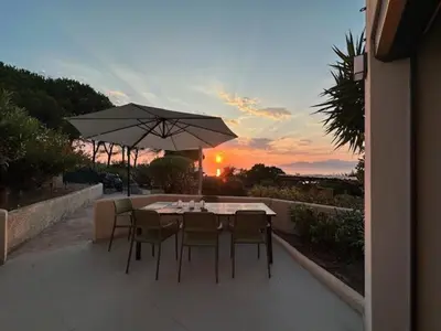 a table with chairs and an umbrella on a patio at Pietrosella Canelli Sea View in Pietrosella