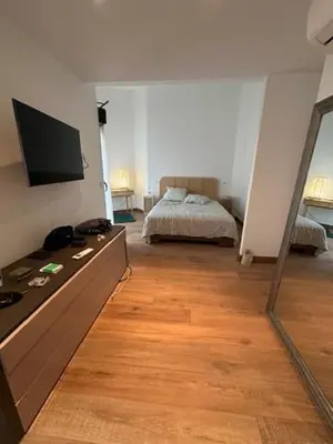 a bedroom with a bed and a dresser with a mirror at Pietrosella Canelli Sea View in Pietrosella