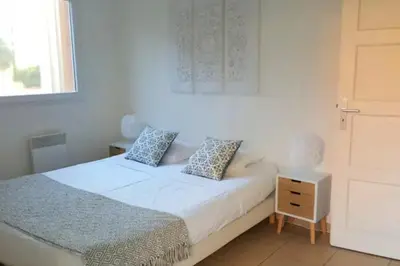 a small bedroom with a bed and a window at 46m with terrace - residence with pool in Porto-Vecchio