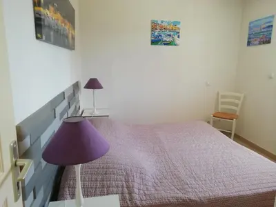 a bedroom with a bed with a purple lamp at Villa sur Travo , Solenzara in Vaccili