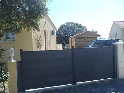 a black fence in front of a house at Villa sur Travo , Solenzara in Vaccili
