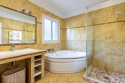 a bathroom with a tub and a sink and a shower at Villa Maria Magdalena - Avec piscine in Sari Solenzara