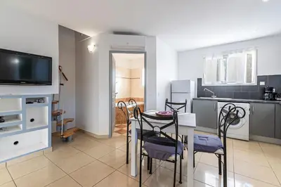 a kitchen and dining room with a table and chairs at Villa Maria Magdalena - Avec piscine in Sari Solenzara