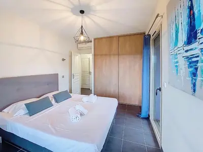 a bedroom with a white bed in a room at Apartment Agnaredda by Interhome in Porto-Vecchio