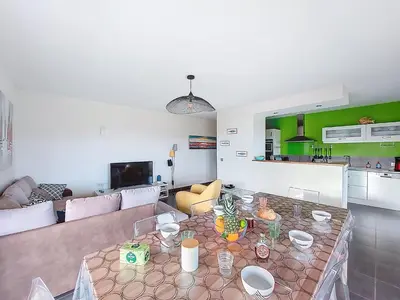 a living room with a table and a couch at Apartment Agnaredda by Interhome in Porto-Vecchio