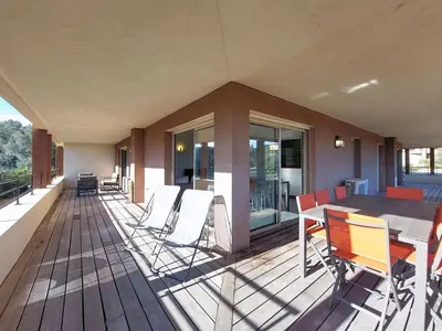 a deck with a table and chairs on a house at Apartment Agnaredda by Interhome in Porto-Vecchio