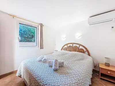 a bedroom with a bed with towels on it at Apartment Marina Di Santa Giulia by Interhome in Porto-Vecchio