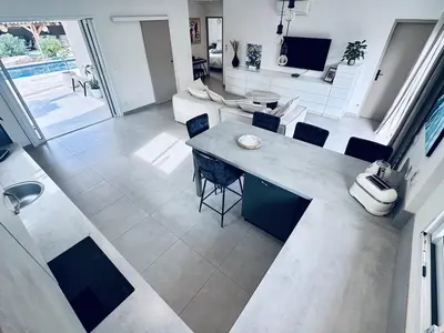an overhead view of a living room with a table and chairs at Villa with pool near Porto-Vecchio beaches in Porto-Vecchio
