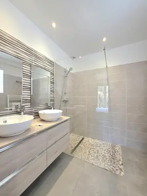 a bathroom with a sink and a toilet and a mirror at Villa with pool near Porto-Vecchio beaches in Porto-Vecchio