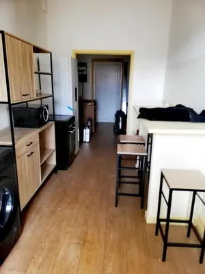 a room with a kitchen and a table and chairs at T2 hyper centre ville in Ajaccio