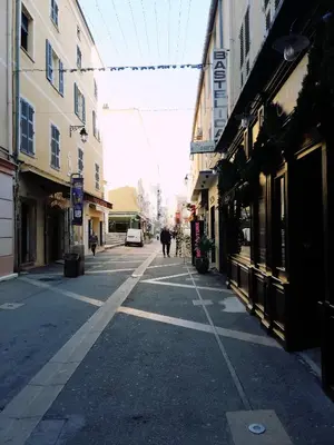 an empty city street with people walking down the street at T2 hyper centre ville in Ajaccio