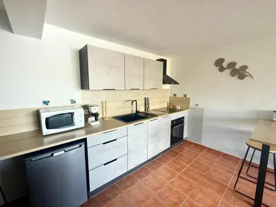 a kitchen with white cabinets and a sink and a microwave at Appartement 4 personnes - Soléa 229 - Vue Mer in Serra-di-Ferro