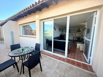 a patio with a table and chairs and a bedroom at Appartement 4 personnes - Soléa 229 - Vue Mer in Serra-di-Ferro