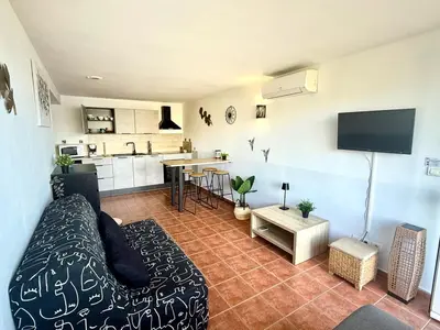 a living room with a couch and a kitchen at Appartement 4 personnes - Soléa 229 - Vue Mer in Serra-di-Ferro