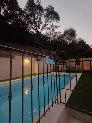 a fence next to a swimming pool at Haut de Villa Superbe vue Piscine privee in Moltifao