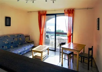 a living room with a couch and a table at Residence I Delfini in Tiuccia