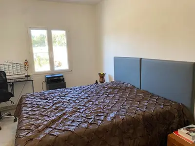 a bedroom with a bed in a room with a window at Cozy villa with pool in Eccica-Suarella
