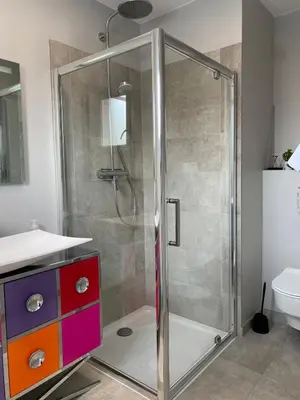 a shower with a glass door in a bathroom at Cozy villa with pool in Eccica-Suarella