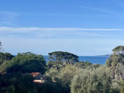 a house on a hill with the ocean in the background at T2 à 200m des plages in Propriano