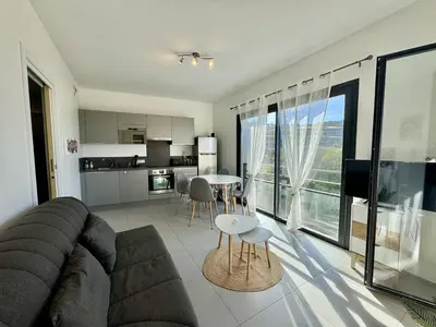 a living room with a couch and a table at T2 à 200m des plages in Propriano