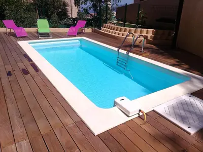 a swimming pool on a deck with chairs around it at A Casa di Natalina in Piana