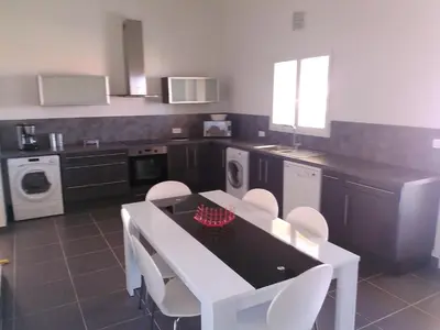 a kitchen with a white table and white chairs at A Casa di Natalina in Piana
