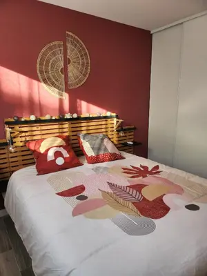 a bedroom with a large bed with red walls at Corsu di Core - Villa Core di Favona in Conca