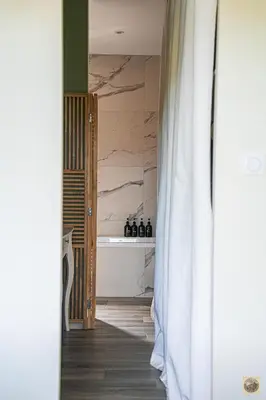 a bathroom with a tub and a shower curtain at Corsu di Core - Villa Core di Favona in Conca