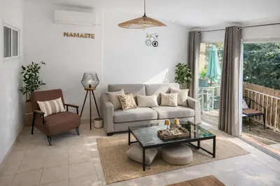a living room with a couch and a table at Appartement 40 m2 Piscine vue panoramique sur Cupabia in Serra-di-Ferro