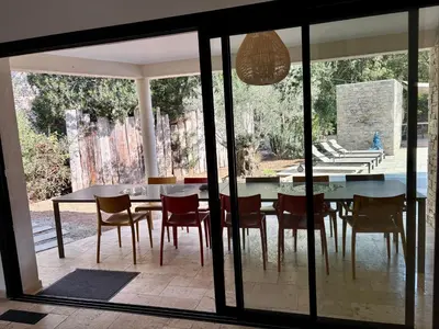 a patio with a table and chairs and a pool at Villa Mare e Monte - Cala Rossa in Porto-Vecchio