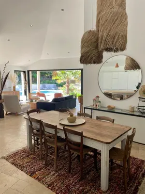 a kitchen and dining room with a wooden table and chairs at Villa Mare e Monte - Cala Rossa in Porto-Vecchio