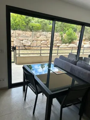a room with a glass table and a couch at Casa Mana-Y in Zonza