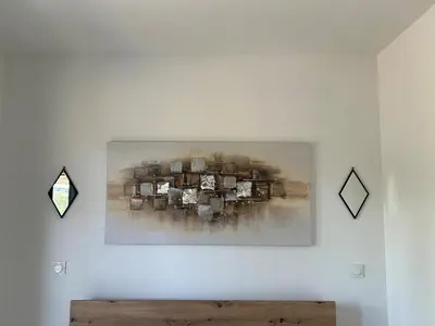 a painting hanging on a wall in a room at Casa Mana-Y in Zonza
