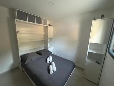 a bedroom with a bed with two pillows on it at Casa Mana-Y in Zonza