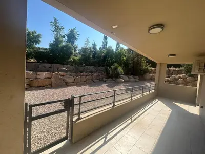 a balcony with a fence and a stone wall at Casa Mana-Y in Zonza