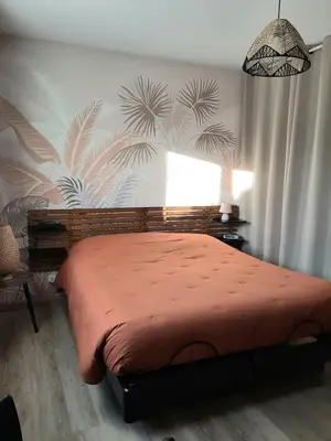 a bedroom with a bed with a red blanket at Villa LICCIA in Prunelli-di-Fiumorbo