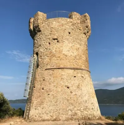 a tall brick tower with a ladder on top at Mini villa dans résidence calme wifi piscine mer à pied in Serra-di-Ferro