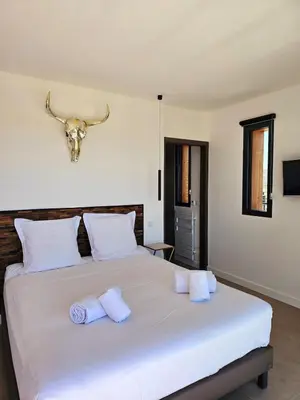 a bedroom with a bed with a bull skull on the wall at Roof Top AVRETTU - Vue Panoramique & Design in Porto-Vecchio