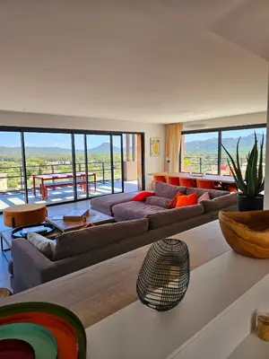 a large living room with couches and a table at Roof Top AVRETTU - Vue Panoramique & Design in Porto-Vecchio