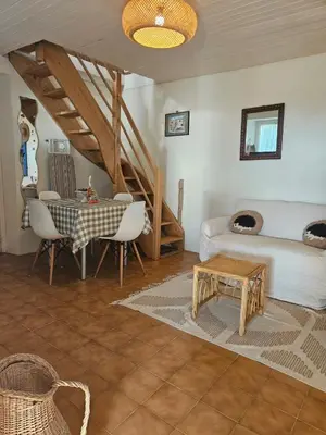 a living room with a table and a couch at La Maisonnette , 2 personnes, charming cottage, 4 km from the beaches in Cargèse