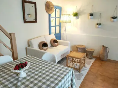 a living room with a table and a couch at La Maisonnette , 2 personnes, charming cottage, 4 km from the beaches in Cargèse