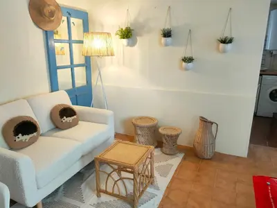 a living room with a couch and a table at La Maisonnette , 2 personnes, charming cottage, 4 km from the beaches in Cargèse