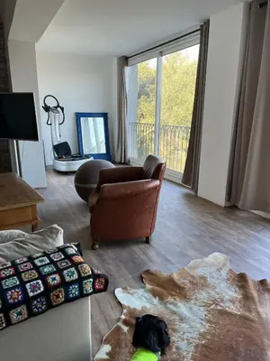 a living room with a couch and a chair at Villa avec vue et piscine privée in Moltifao